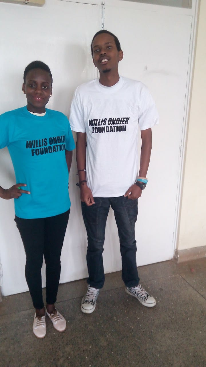 Two Foundation supporters wearing Willis Ondiek Foundation shirts