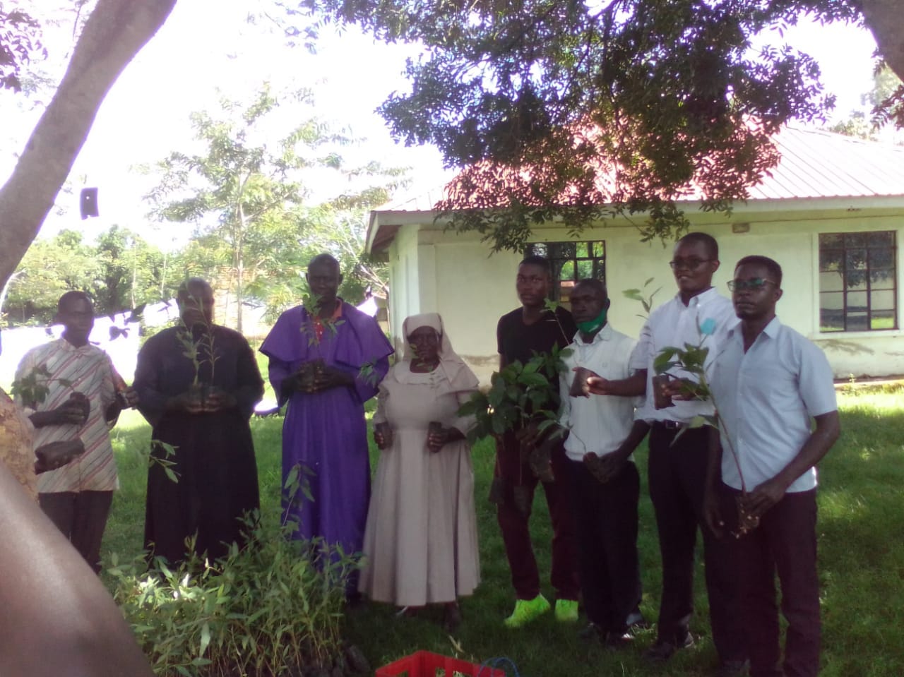 Faith leaders holding seedlings