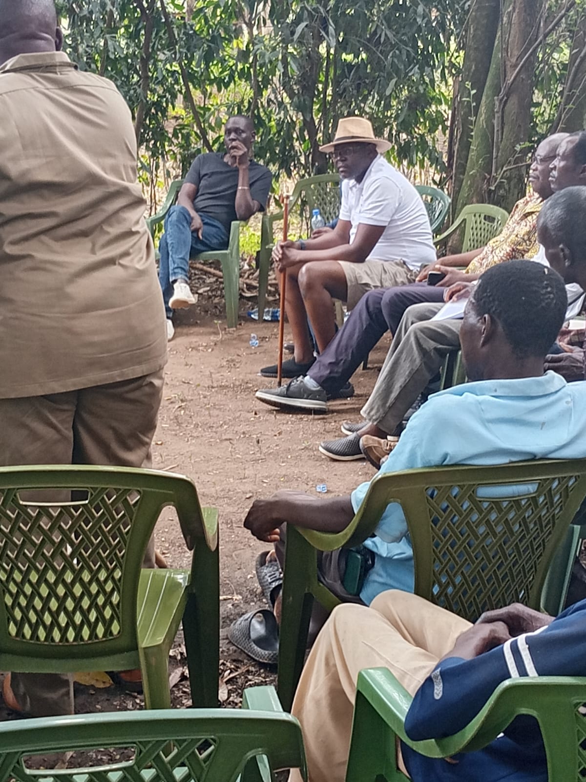 Participants listening during an outdoor community meeting