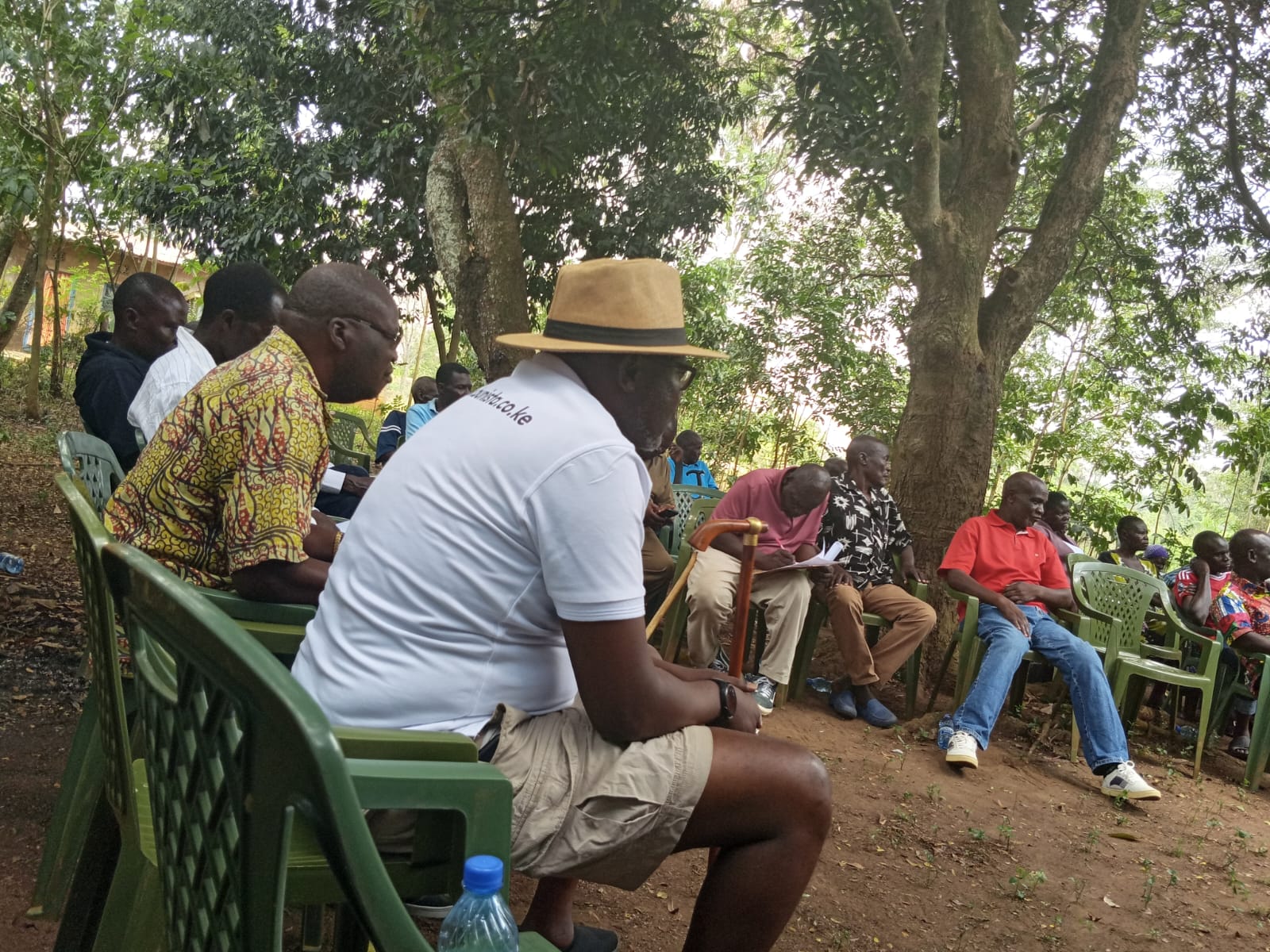 Rev. Father Willis Ondiek seated among community members