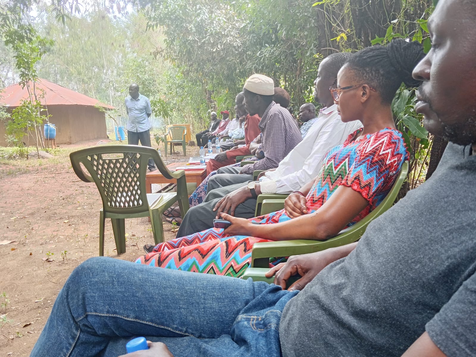 Women and men attending an outdoor discussion