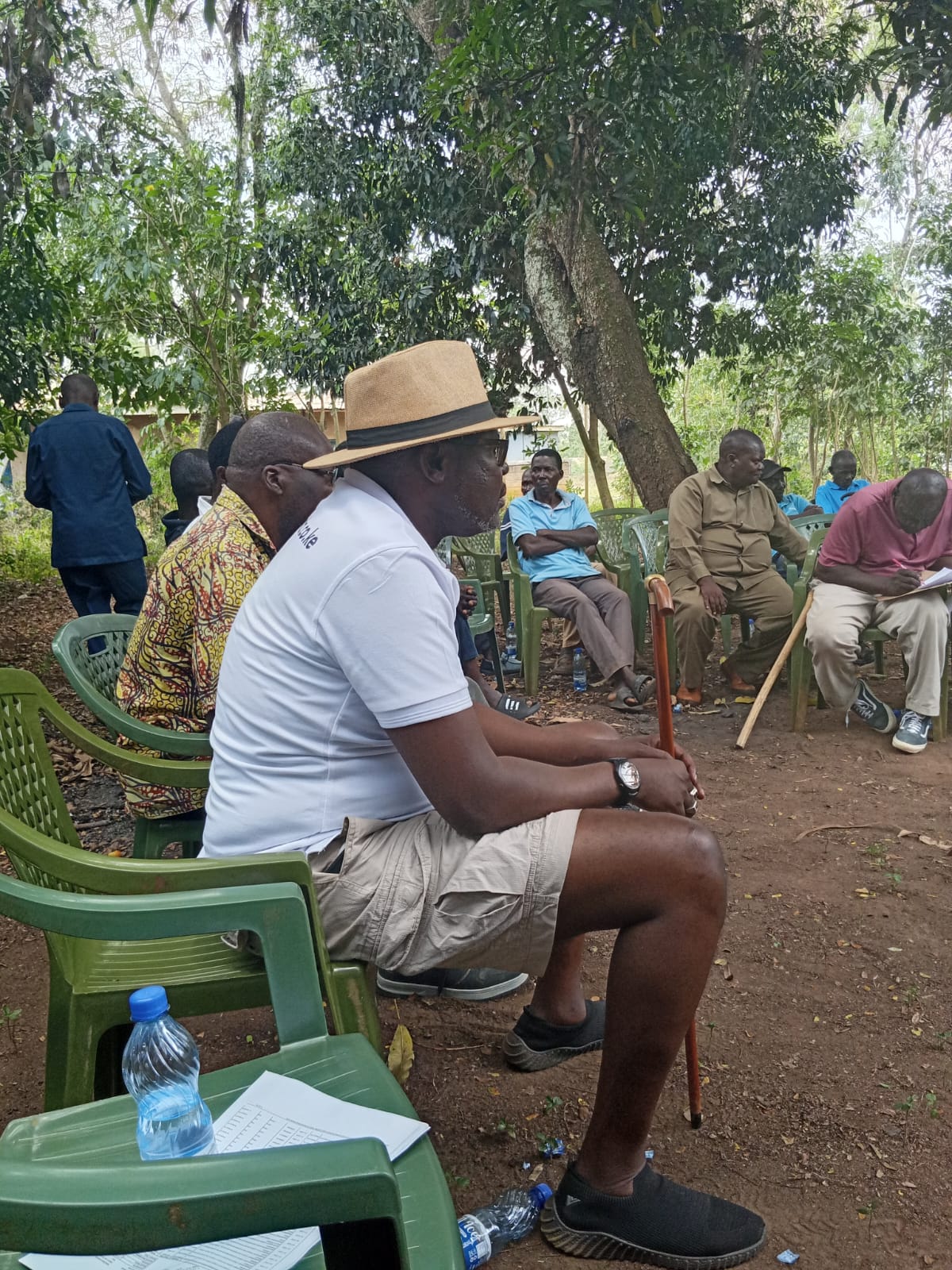 Rev. Father Willis Ondiek seated at a community dialogue