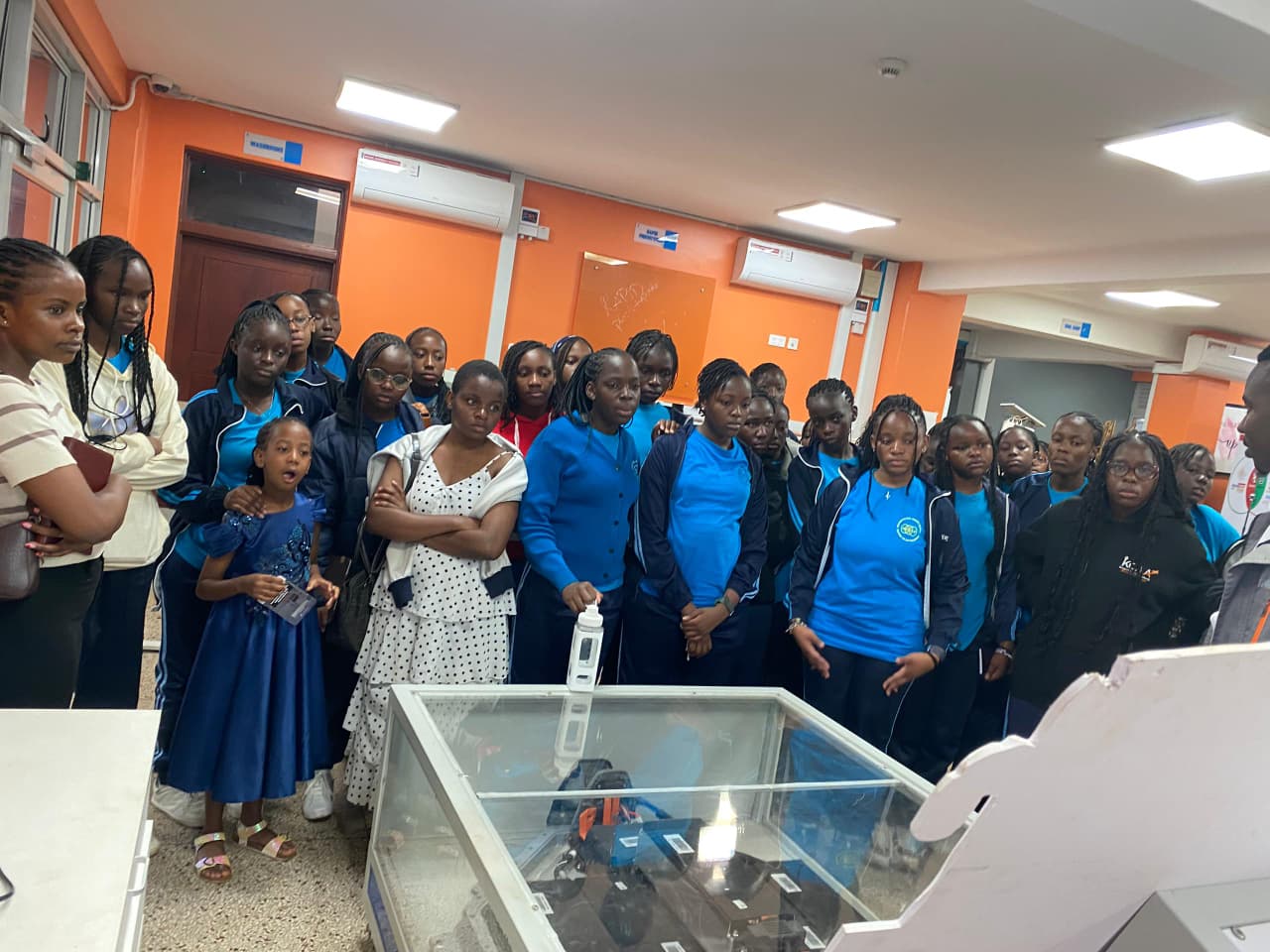 Young people observing a technology display during a learning visit